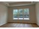 Bedroom with hardwood floors, a large bright window, and white trim at 45 Northbrook Dr, Murrells Inlet, SC 29576