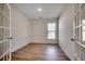 Well-lit room with modern flooring, a large window, and stylish French doors for a versatile space at 45 Northbrook Dr, Murrells Inlet, SC 29576