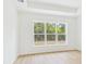 Bedroom with wood flooring, large windows overlooking the backyard, and a tray ceiling at 45 Northbrook Dr, Murrells Inlet, SC 29576