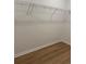 Empty walk-in closet with hanging racks and wood floor at 45 Northbrook Dr, Murrells Inlet, SC 29576