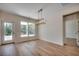Dining room with wood flooring, stylish light fixture, a door to the backyard, and large window at 45 Northbrook Dr, Murrells Inlet, SC 29576