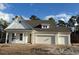 Two-story home with white siding, gray roof and two-car garage at 45 Northbrook Dr, Murrells Inlet, SC 29576