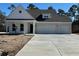 Charming one-story home featuring white siding and a three-car garage at 45 Northbrook Dr, Murrells Inlet, SC 29576