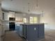 Modern kitchen with white cabinets, gray island and gold fixtures at 45 Northbrook Dr, Murrells Inlet, SC 29576