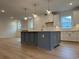 Kitchen island featuring a white countertop, gray cabinets, and elegant pendant lighting at 45 Northbrook Dr, Murrells Inlet, SC 29576