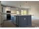 Bright kitchen featuring a center island, stainless steel appliances, and white cabinetry at 45 Northbrook Dr, Murrells Inlet, SC 29576