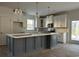 Modern kitchen with white cabinets, gray island and gold fixtures at 45 Northbrook Dr, Murrells Inlet, SC 29576