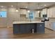 Modern kitchen featuring stainless steel appliances, a gray island, and white cabinets at 45 Northbrook Dr, Murrells Inlet, SC 29576