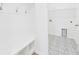 Laundry room with patterned tile floor, built in bench, and utility sink connection at 45 Northbrook Dr, Murrells Inlet, SC 29576