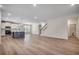 Bright open-concept living space featuring modern flooring and an island kitchen with stainless steel appliances at 45 Northbrook Dr, Murrells Inlet, SC 29576
