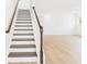 Staircase leading to living area with hardwood floors at 45 Northbrook Dr, Murrells Inlet, SC 29576