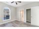 Well-lit bedroom, featuring wood-look floors and an arched window at 4705 Wild Iris Dr. # 105, Myrtle Beach, SC 29577