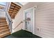 Exterior condo entry with wooden stairs and wreath at 4725 Wild Iris Dr. # 202, Myrtle Beach, SC 29577