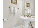 Charming half-bath with pedestal sink, decorative accents, and vintage-style fixtures at 4846 Carnation Circle # 203, Myrtle Beach, SC 29577