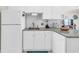 Kitchen featuring white cabinets, granite countertops, and stainless steel sink at 4846 Carnation Circle # 203, Myrtle Beach, SC 29577
