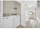 Laundry area equipped with a washer, dryer, and shelving at 4846 Carnation Circle # 203, Myrtle Beach, SC 29577