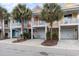 Row of colorful townhouses with garages and landscaping at 4919 Cinzia Ln. # 6-B, North Myrtle Beach, SC 29582