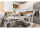 Clean kitchen with stainless steel sink, granite countertop, and white cabinets at 4919 Cinzia Ln. # 6-B, North Myrtle Beach, SC 29582