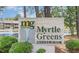 Myrtle Greens Condominium sign with pond and fountain in background at 500 Myrtle Greens Dr. # A, Conway, SC 29526