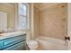 Bathroom with teal vanity, shower/tub combo and updated tile at 55 Pineberry Dr., Georgetown, SC 29440