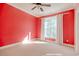 Spacious bedroom with coral walls, plush carpeting, and a large window at 55 Pineberry Dr., Georgetown, SC 29440