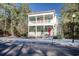 Two-story house with light green exterior, red door, and white columns at 55 Pineberry Dr., Georgetown, SC 29440