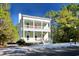 Two-story house with light green exterior, red door, and white columns at 55 Pineberry Dr., Georgetown, SC 29440