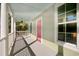 Front porch with white columns, light blue ceiling, and pink door at 55 Pineberry Dr., Georgetown, SC 29440