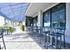 Outdoor patio seating area with striped awning and ocean view at 5511 N Ocean Blvd. # 309, Myrtle Beach, SC 29577