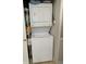 Stackable washer and dryer in a closet with shelving at 601 N Hillside Dr. # 4235, North Myrtle Beach, SC 29582