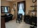 Home office with a piano, chair, and built-in shelves at 601 N Hillside Dr. # 4235, North Myrtle Beach, SC 29582