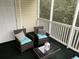 Relaxing screened porch with wicker furniture and a view of trees at 601 N Hillside Dr. # 4235, North Myrtle Beach, SC 29582