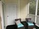 Screened porch with two wicker chairs and a small table at 601 N Hillside Dr. # 4235, North Myrtle Beach, SC 29582