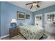 Light blue bedroom with a queen-size bed, ceiling fan, and access to patio at 608 Surfsong Way # 608, North Myrtle Beach, SC 29582