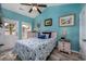 Bedroom with a light blue wall, queen-size bed and private access to backyard at 608 Surfsong Way # 608, North Myrtle Beach, SC 29582