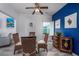 Charming dining area with glass table, wicker chairs, and blue accent wall at 608 Surfsong Way # 608, North Myrtle Beach, SC 29582