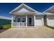 Charming light blue cottage with front porch and attached garage at 608 Surfsong Way # 608, North Myrtle Beach, SC 29582