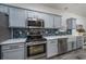 Modern kitchen with light blue cabinets, stainless steel appliances, and farmhouse sink at 608 Surfsong Way # 608, North Myrtle Beach, SC 29582