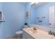 Light blue bathroom with white vanity and nautical decor at 713 N Ocean Blvd. # 204, Surfside Beach, SC 29575