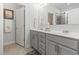 Bathroom featuring double sinks, a large mirror, and a glass-enclosed shower for modern convenience at 901 Queensferry Ct., Conway, SC 29526