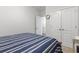 Simple bedroom with neutral carpet and a bed featuring striped bedding, providing a clean and functional living space at 901 Queensferry Ct., Conway, SC 29526