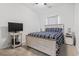 A cozy bedroom featuring a bed with striped bedding, a tv, and a nightstand for a comfortable stay at 901 Queensferry Ct., Conway, SC 29526