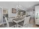 Light-filled dining area with wood floors, neutral tones, and a stylish chandelier over a six-chair table at 901 Queensferry Ct., Conway, SC 29526