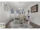 Sunlit dining room featuring a modern chandelier, matching white table set, and decorative blue curtains at 901 Queensferry Ct., Conway, SC 29526