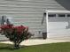 The home's garage is shown and there is a flowering bush nearby at 901 Queensferry Ct., Conway, SC 29526