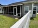 The house includes a screened-in porch, small doggie door and green lawn at 901 Queensferry Ct., Conway, SC 29526
