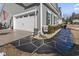 Home's garage and decorative driveway with a lovely flowerbed nearby at 901 Queensferry Ct., Conway, SC 29526