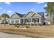 Charming single-story home showcasing a manicured lawn and inviting front porch at 901 Queensferry Ct., Conway, SC 29526