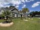 Well-maintained home with lush green lawn and palm tree at 901 Queensferry Ct., Conway, SC 29526