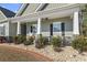 Inviting front porch with rocking chairs and landscaping at 901 Queensferry Ct., Conway, SC 29526